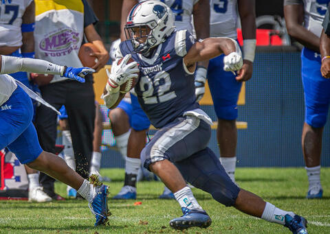 Howard football player running